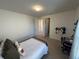 Neutral bedroom features a metal frame bed, desk, and doorway views at 3399 Buoy Cir, Winter Garden, FL 34787