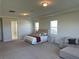 Bedroom features a large bed, a seating area, and plenty of natural light from surrounding windows at 3399 Buoy Cir, Winter Garden, FL 34787