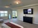 Bedroom featuring neutral decor, an entertainment unit, and a view of the water at 3399 Buoy Cir, Winter Garden, FL 34787