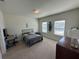 Bright bedroom featuring a metal bed frame, carpet flooring and lots of natural light at 3399 Buoy Cir, Winter Garden, FL 34787