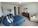 Comfortable bedroom featuring a cozy armchair, modern desk, and metal bed frame at 3399 Buoy Cir, Winter Garden, FL 34787