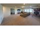 Bright bonus room with a sectional couch and a wall-mounted TV at 3399 Buoy Cir, Winter Garden, FL 34787