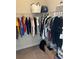 Walk-in closet with clothes hanging on racks and storage on the top shelf at 3399 Buoy Cir, Winter Garden, FL 34787