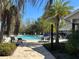 Resort-style community pool surrounded by palm trees, lounge chairs, and patio seating at 3399 Buoy Cir, Winter Garden, FL 34787