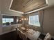 Elegant dining room with wood ceiling, chandelier, and seating for eight at 3399 Buoy Cir, Winter Garden, FL 34787