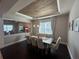 Elegant dining room with wood ceiling, chandelier, and seating for eight at 3399 Buoy Cir, Winter Garden, FL 34787