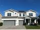 Inviting two-story home with a gray two-car garage and well-maintained landscaping and gray trim at 3399 Buoy Cir, Winter Garden, FL 34787