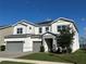 Beautiful two-story home featuring a three-car garage and manicured lawn at 3399 Buoy Cir, Winter Garden, FL 34787