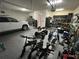 Garage with an epoxy floor and filled with a variety of vehicles and equipment at 3399 Buoy Cir, Winter Garden, FL 34787
