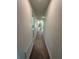 Neutral hallway featuring carpet, white walls and trim, leading to various rooms at 3399 Buoy Cir, Winter Garden, FL 34787