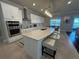 Modern kitchen featuring stainless steel appliances, a large island with seating, and ample cabinet space at 3399 Buoy Cir, Winter Garden, FL 34787