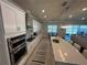 Open kitchen layout with a view of the living area, stainless steel appliances, and a central island at 3399 Buoy Cir, Winter Garden, FL 34787