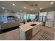 Spacious open-concept kitchen island with seating, stainless appliances, and a connected living area at 3399 Buoy Cir, Winter Garden, FL 34787