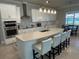 Bright kitchen featuring stainless steel appliances, a large island with seating, and plenty of counter space at 3399 Buoy Cir, Winter Garden, FL 34787