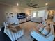 Comfortable living room showcasing plush seating, a modern ceiling fan, and stylish decor at 3399 Buoy Cir, Winter Garden, FL 34787