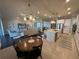 Bright living space features hardwood floors, kitchen island, open layout, with a dinette at 3399 Buoy Cir, Winter Garden, FL 34787