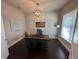 Well-lit home office with wood floors, wainscotting, and a rustic desk at 3399 Buoy Cir, Winter Garden, FL 34787