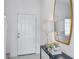 Inviting entryway featuring stylish decor, a console table, a sleek mirror, and a bright front door at 3527 Mayfair St, Kissimmee, FL 34758