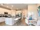Open-concept kitchen with stainless steel appliances, granite counters, and dining area at 3527 Mayfair St, Kissimmee, FL 34758