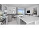 Open concept kitchen, overlooking the living room, featuring stainless steel appliances and a large island at 3527 Mayfair St, Kissimmee, FL 34758