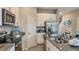 Modern kitchen with stainless steel appliances, granite countertops, and tiled flooring at 3527 Mayfair St, Kissimmee, FL 34758