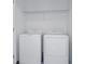 Efficient laundry space with a full-size washer and dryer set and practical shelving for storage at 3527 Mayfair St, Kissimmee, FL 34758
