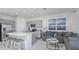 Modern living area showcases a spacious island, stainless steel appliances, and comfortable gray sectional sofa at 3527 Mayfair St, Kissimmee, FL 34758
