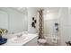 Bright bathroom features a white vanity, quartz countertop, and a shower-tub combo at 3535 Mayfair St, Kissimmee, FL 34758