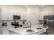 Modern kitchen featuring stainless steel appliances, white cabinetry, an island and stylish countertops at 3535 Mayfair St, Kissimmee, FL 34758