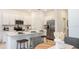 Bright kitchen with white cabinets, stainless steel appliances, and quartz countertops with bar stool seating at 3535 Mayfair St, Kissimmee, FL 34758