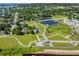 Panoramic aerial perspective of the park with a lake, trails, and surrounding neighborhood at 403 Shoreview Sands Ave, Mascotte, FL 34753
