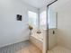 Bright bathroom featuring a standalone shower and a large bathtub under the window at 4729 Spindletree Ln, Orlando, FL 32829