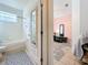 Bright bathroom featuring a bathtub, tiled floors and a view into the next room at 4729 Spindletree Ln, Orlando, FL 32829