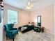 Stylish bedroom features accent wall, neutral rug, accent chair and a bright, well-lit window at 4729 Spindletree Ln, Orlando, FL 32829