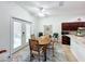 Dining room with modern lighting and double doors opening to an outdoor living space at 4729 Spindletree Ln, Orlando, FL 32829