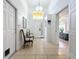 Bright foyer features a high ceiling, neutral tile flooring, and access to a bedroom, creating an inviting entrance at 4729 Spindletree Ln, Orlando, FL 32829