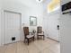 Bright foyer features a high ceiling, neutral tile flooring, and a decorative mirror for an inviting entrance at 4729 Spindletree Ln, Orlando, FL 32829