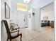 Bright foyer features a high ceiling, neutral tile flooring, and access to a bedroom, creating an inviting entrance at 4729 Spindletree Ln, Orlando, FL 32829