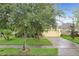 One-story home with a well-manicured lawn, complemented by mature trees, enhancing the curb appeal at 4729 Spindletree Ln, Orlando, FL 32829