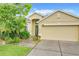 Inviting single-Gathering home with a lush, landscaped front yard and a two-car garage, offering curb appeal at 4729 Spindletree Ln, Orlando, FL 32829