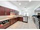 Modern kitchen featuring tile flooring, stainless appliances, and ample countertop space at 4729 Spindletree Ln, Orlando, FL 32829