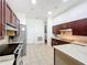 Spacious kitchen features stainless steel appliances and light colored tile floor at 4729 Spindletree Ln, Orlando, FL 32829