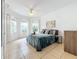 Sunlit main bedroom showcasing stylish decor, tile floors, and large windows with serene views at 4729 Spindletree Ln, Orlando, FL 32829