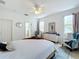 Bright main bedroom featuring a bed, dresser, seating and a view to the bathroom at 4729 Spindletree Ln, Orlando, FL 32829