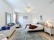 Spacious main bedroom with a bed, dresser, and a comfortable chair near the window at 4729 Spindletree Ln, Orlando, FL 32829