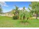 Corner lot featuring green grass and palm trees that accent the property, enhancing its curb appeal at 4729 Spindletree Ln, Orlando, FL 32829