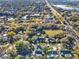 High angle view of a residential area with lush trees, green lawns, and neighborhood streets at 4916 Winwood Way, Orlando, FL 32819