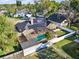 Aerial view of a house featuring solar panels and a screened pool, showcasing its prime location at 4916 Winwood Way, Orlando, FL 32819