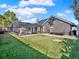 Expansive backyard featuring a screened pool area, lush lawn, and mature landscaping at 4916 Winwood Way, Orlando, FL 32819