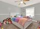 Cozy bedroom with plush carpeting, a ceiling fan, and plenty of natural light at 4916 Winwood Way, Orlando, FL 32819
